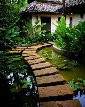 Slabs make a floating stepping stone path over pond